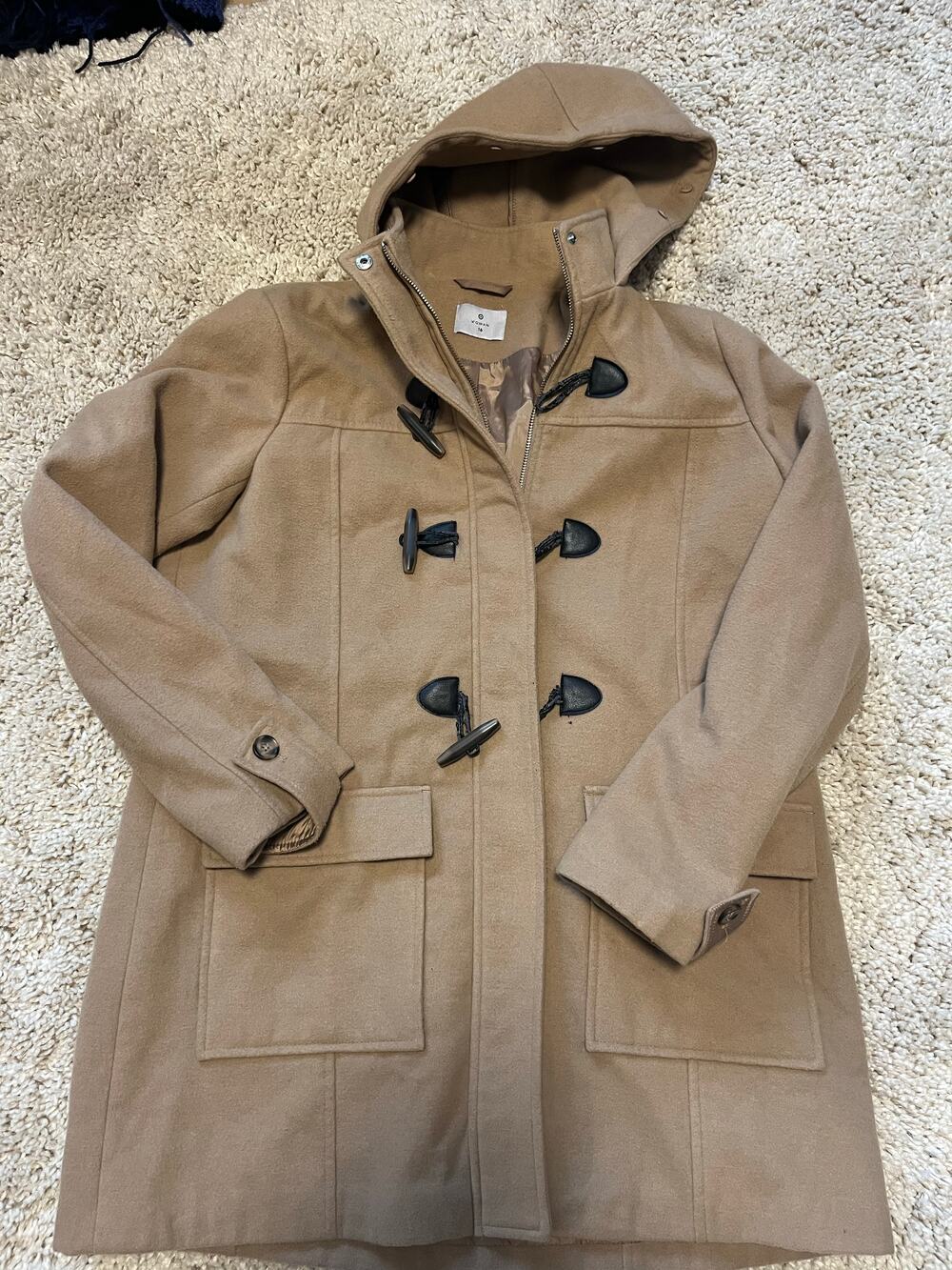 Tan hooded duffle coat with toggle front closure and flap pockets